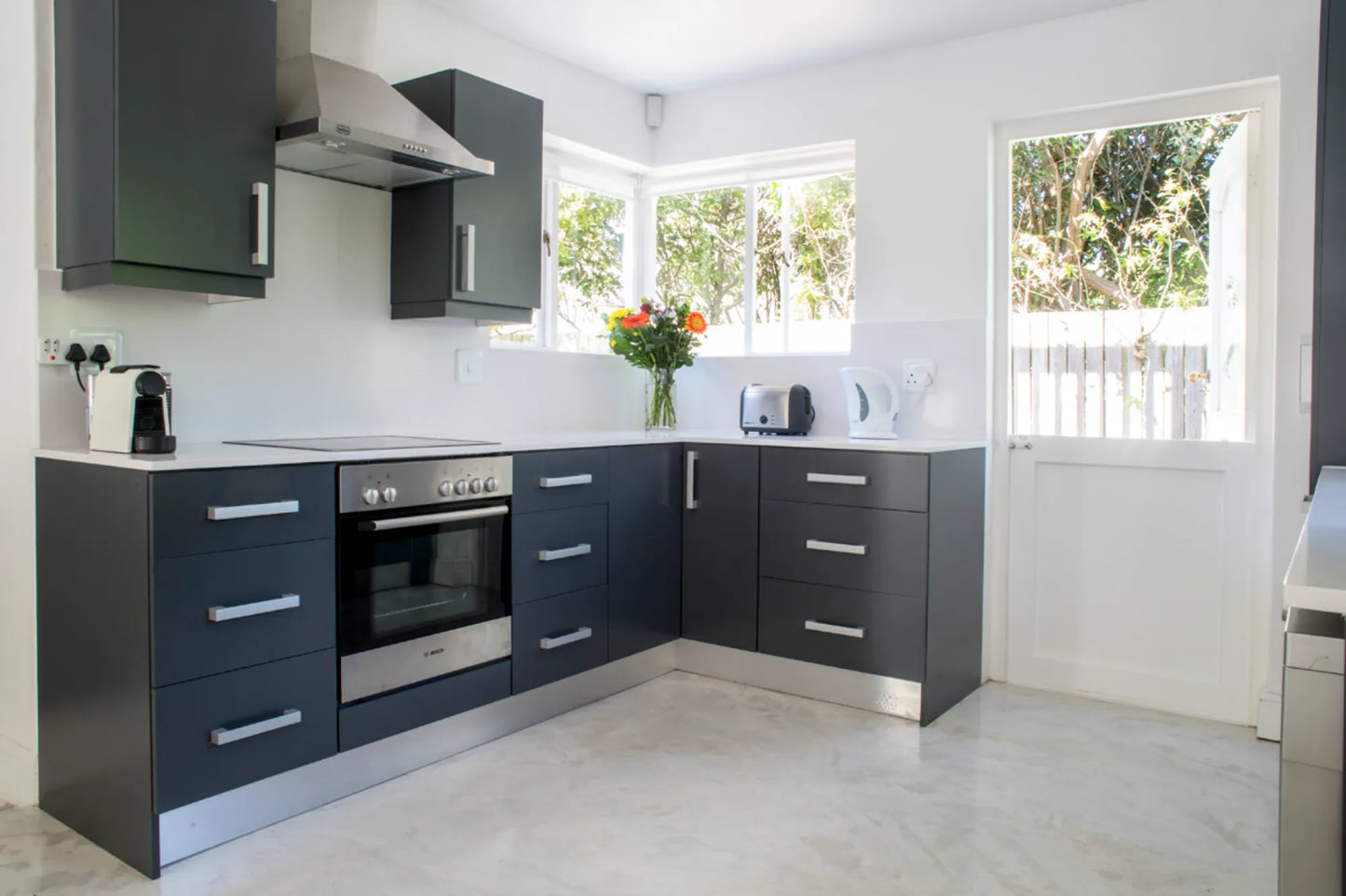 Candlewood Cottage, a thatched holiday villa in St. Francis Bay nestled among Candlewood trees. A serene self-catering retreat sleeping up to 8 guests, featuring elegant, pared-down interiors, a cosy loft with its own TV and kitchenette, and easy access to canals and the beach.