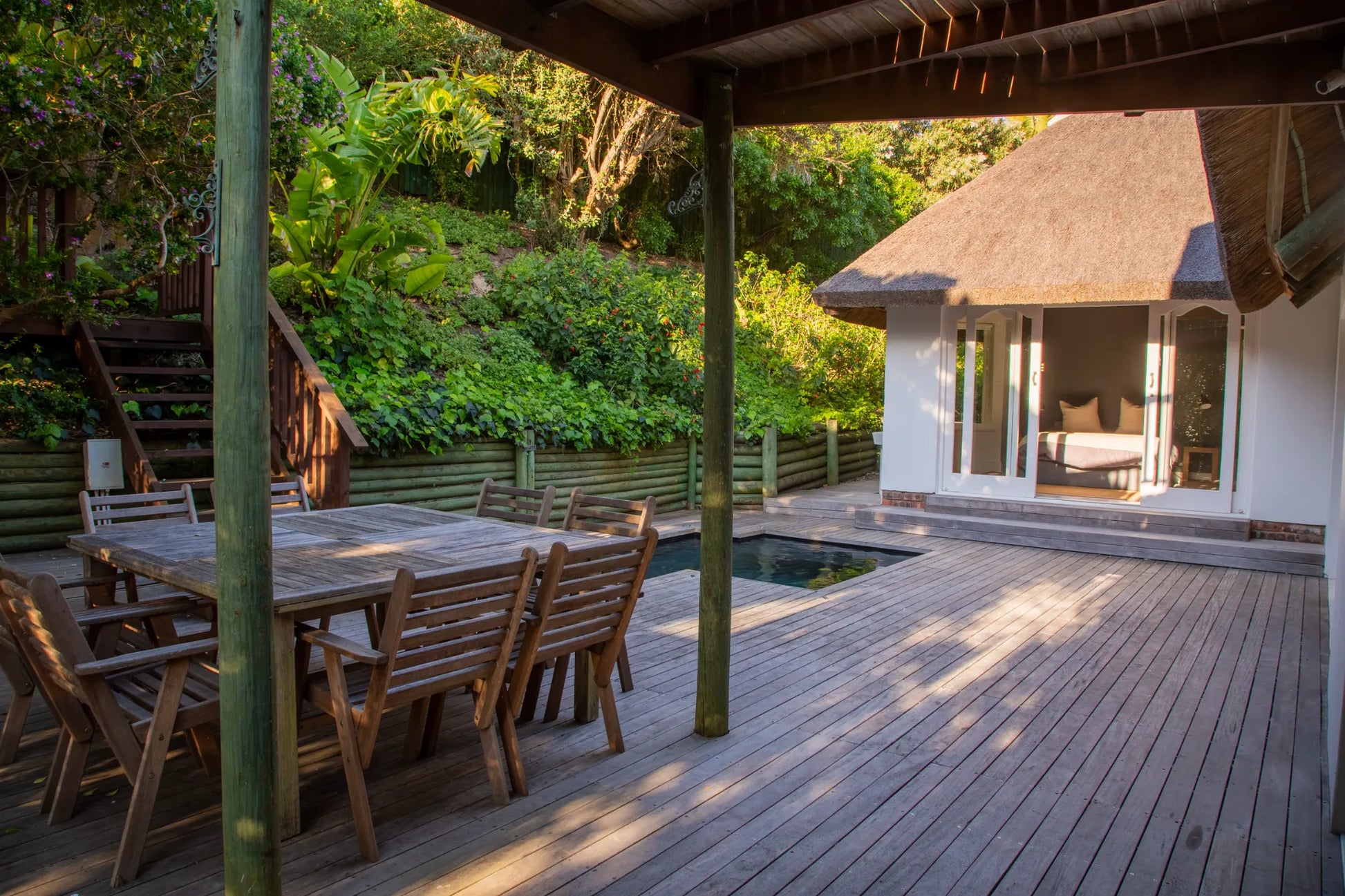 Candlewood Cottage, a thatched holiday villa in St. Francis Bay nestled among Candlewood trees. A serene self-catering retreat sleeping up to 8 guests, featuring elegant, pared-down interiors, a cosy loft with its own TV and kitchenette, and easy access to canals and the beach.