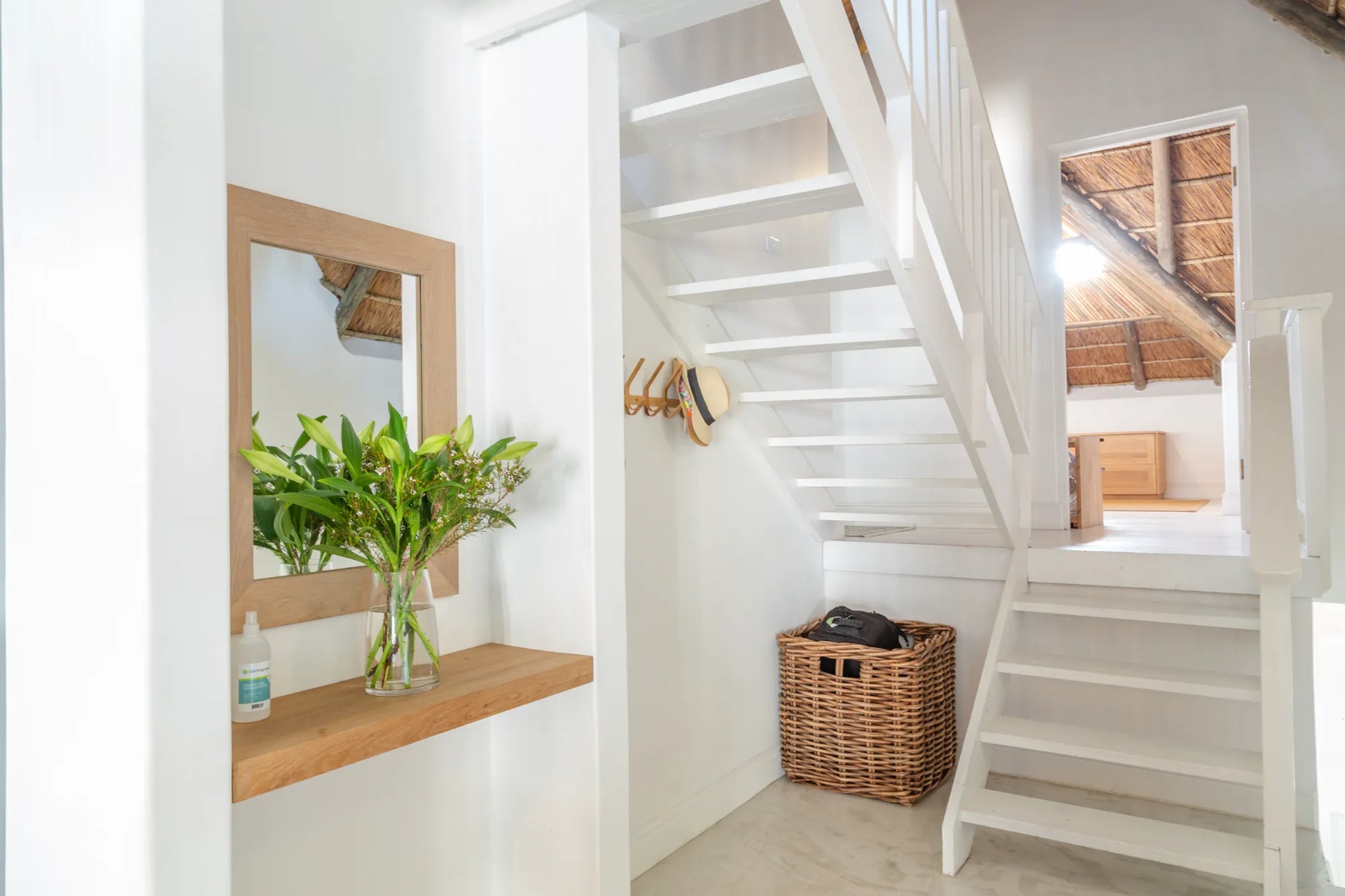 Candlewood Cottage, a thatched holiday villa in St. Francis Bay nestled among Candlewood trees. A serene self-catering retreat sleeping up to 8 guests, featuring elegant, pared-down interiors, a cosy loft with its own TV and kitchenette, and easy access to canals and the beach.