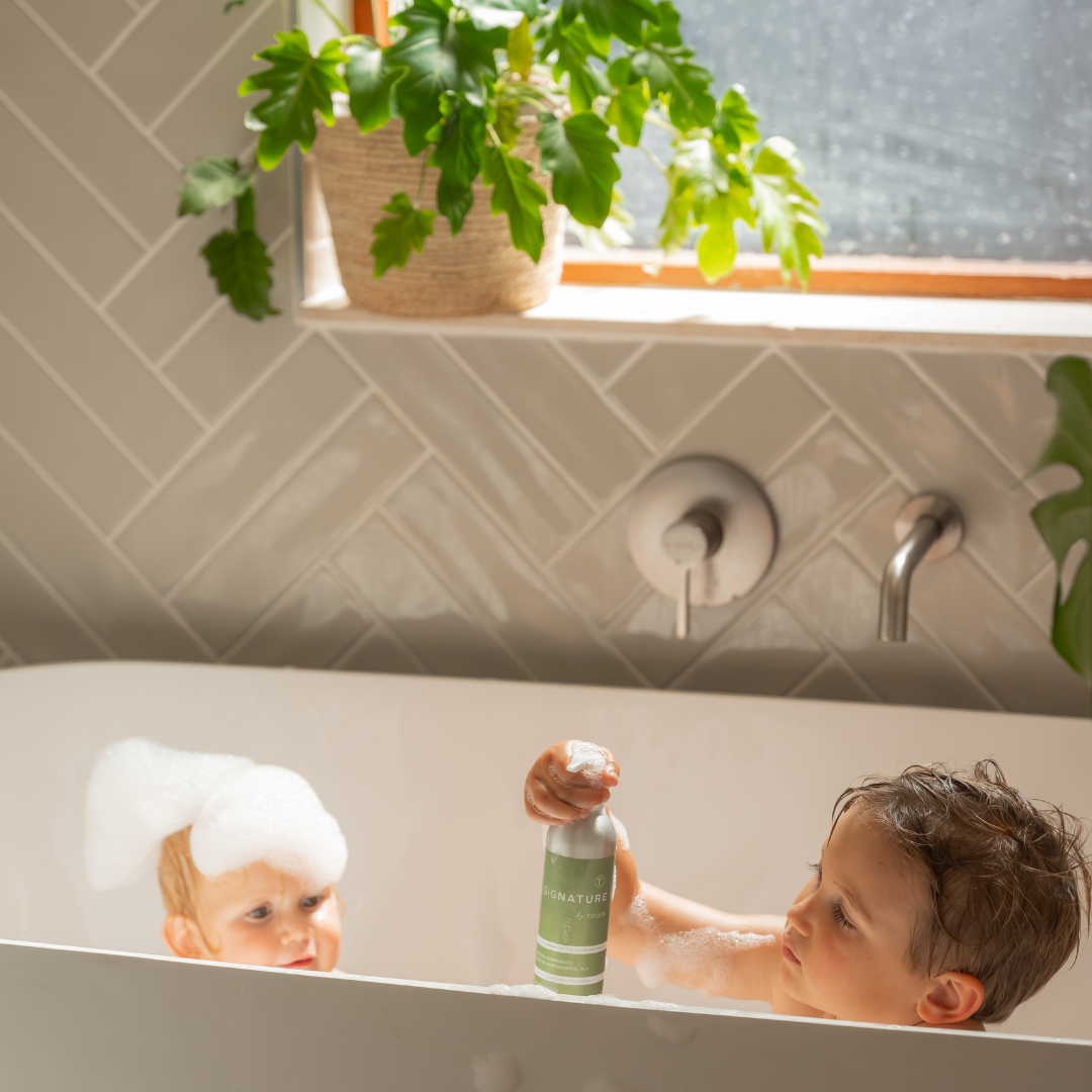 sigNATURE Wash creating soft, fragrant bubbles in a warm bath. Made with natural ingredients and pure essential oils, this luxurious, locally made formula transforms into a soothing bubble bath — gentle, moisturizing, and free from SLS, parabens, and palm oil.