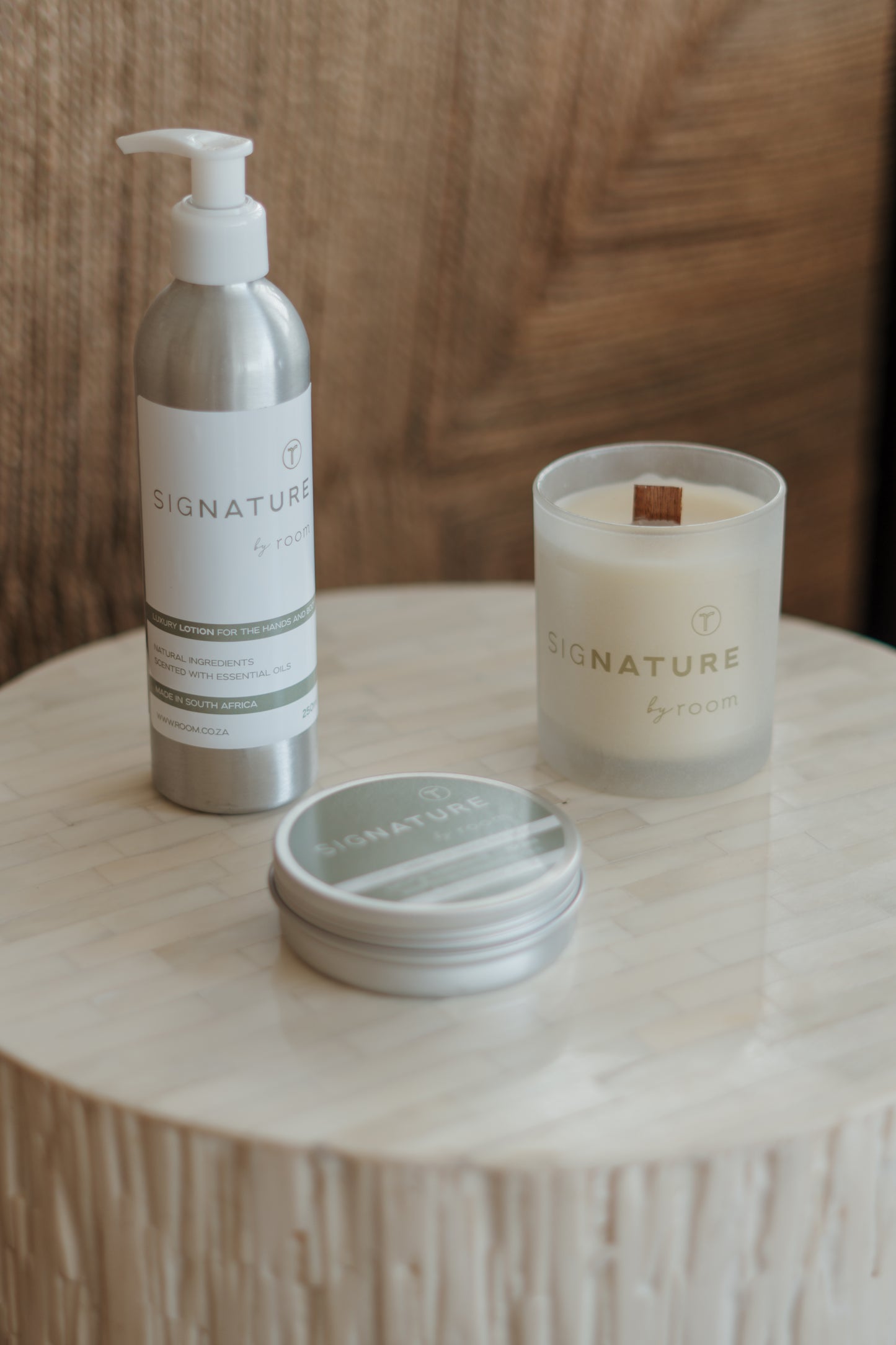 Luxurious self-care bundle featuring sigNATURE Lotion, richly hydrating Body Butter, and a naturally scented soy and coconut wax Candle with a wooden wick. Crafted locally with pure essential oils — a nourishing, all-natural trio free from SLS, parabens, and palm oil.