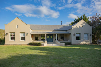Peacehaven Cottage, a luxurious holiday home on the banks of the Breede River with a grand farmhouse feel. The property includes a spacious Manor House sleeping 8 guests and two stylishly converted Boat Sheds, each accommodating 2 guests.