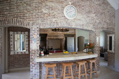 Peacehaven Cottage, a luxurious holiday home on the banks of the Breede River with a grand farmhouse feel. The property includes a spacious Manor House sleeping 8 guests and two stylishly converted Boat Sheds, each accommodating 2 guests.