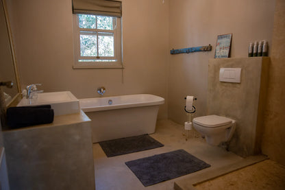 Peacehaven Cottage, a luxurious holiday home on the banks of the Breede River with a grand farmhouse feel. The property includes a spacious Manor House sleeping 8 guests and two stylishly converted Boat Sheds, each accommodating 2 guests.