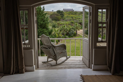 Peacehaven Cottage, a luxurious holiday home on the banks of the Breede River with a grand farmhouse feel. The property includes a spacious Manor House sleeping 8 guests and two stylishly converted Boat Sheds, each accommodating 2 guests.