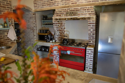 Peacehaven Cottage, a luxurious holiday home on the banks of the Breede River with a grand farmhouse feel. The property includes a spacious Manor House sleeping 8 guests and two stylishly converted Boat Sheds, each accommodating 2 guests.