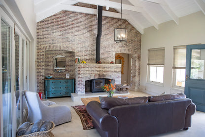 Peacehaven Cottage, a luxurious holiday home on the banks of the Breede River with a grand farmhouse feel. The property includes a spacious Manor House sleeping 8 guests and two stylishly converted Boat Sheds, each accommodating 2 guests.