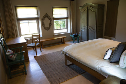 Peacehaven Cottage, a luxurious holiday home on the banks of the Breede River with a grand farmhouse feel. The property includes a spacious Manor House sleeping 8 guests and two stylishly converted Boat Sheds, each accommodating 2 guests.