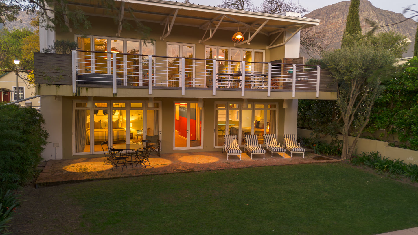 Modern house with a deck and outdoor furniture in a residential area.