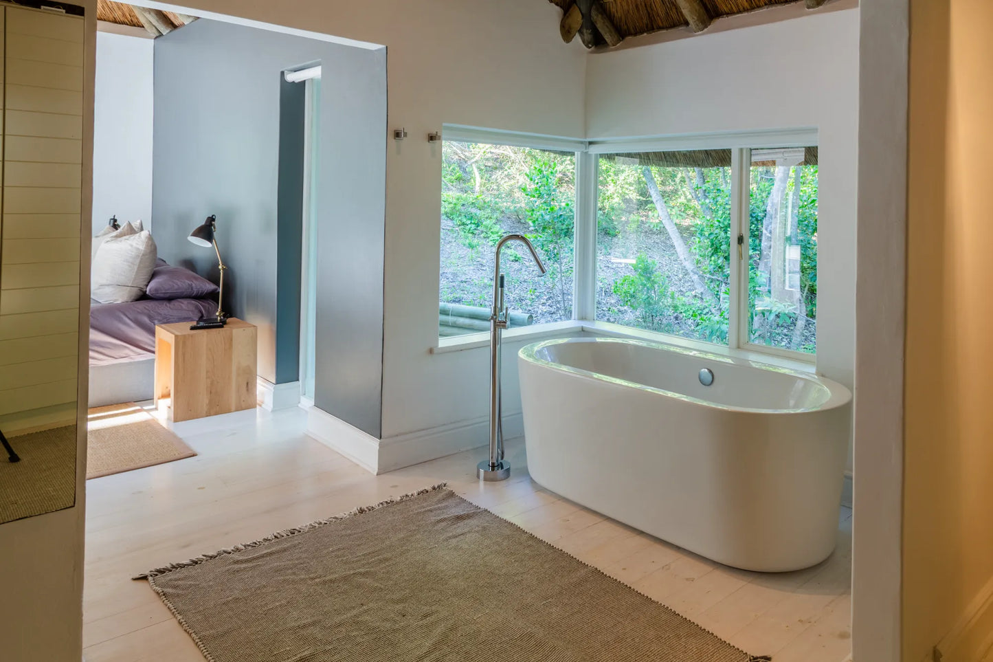 Candlewood Cottage, a thatched holiday villa in St. Francis Bay nestled among Candlewood trees. A serene self-catering retreat sleeping up to 8 guests, featuring elegant, pared-down interiors, a cosy loft with its own TV and kitchenette, and easy access to canals and the beach.