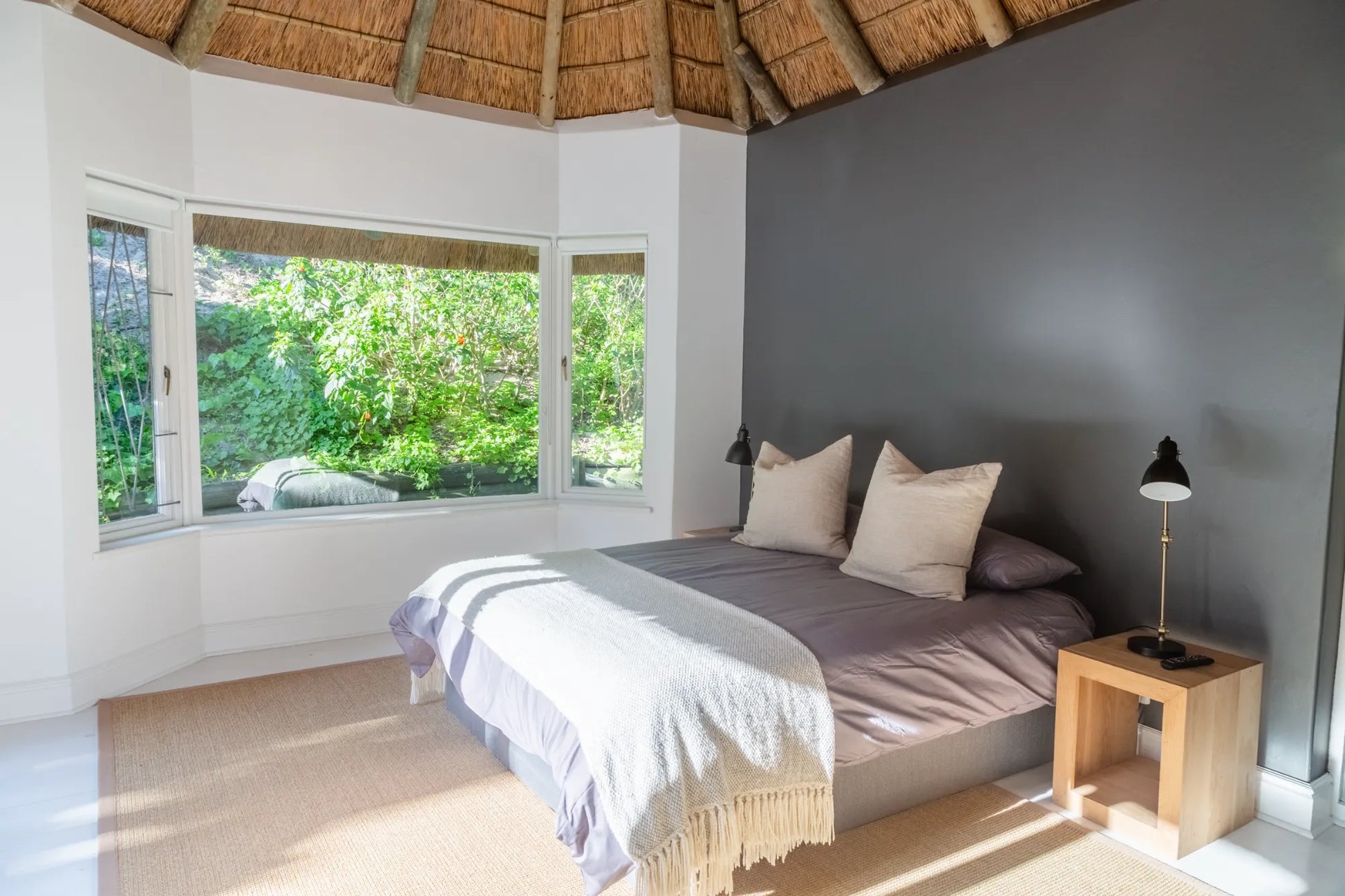 Candlewood Cottage, a thatched holiday villa in St. Francis Bay nestled among Candlewood trees. A serene self-catering retreat sleeping up to 8 guests, featuring elegant, pared-down interiors, a cosy loft with its own TV and kitchenette, and easy access to canals and the beach.