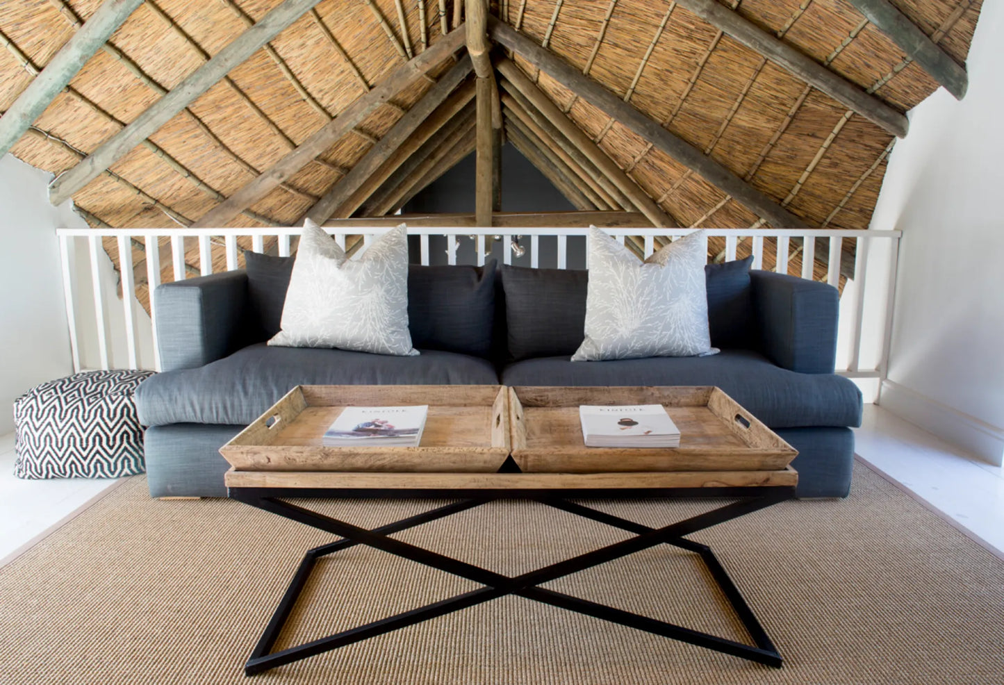 Candlewood Cottage, a thatched holiday villa in St. Francis Bay nestled among Candlewood trees. A serene self-catering retreat sleeping up to 8 guests, featuring elegant, pared-down interiors, a cosy loft with its own TV and kitchenette, and easy access to canals and the beach.