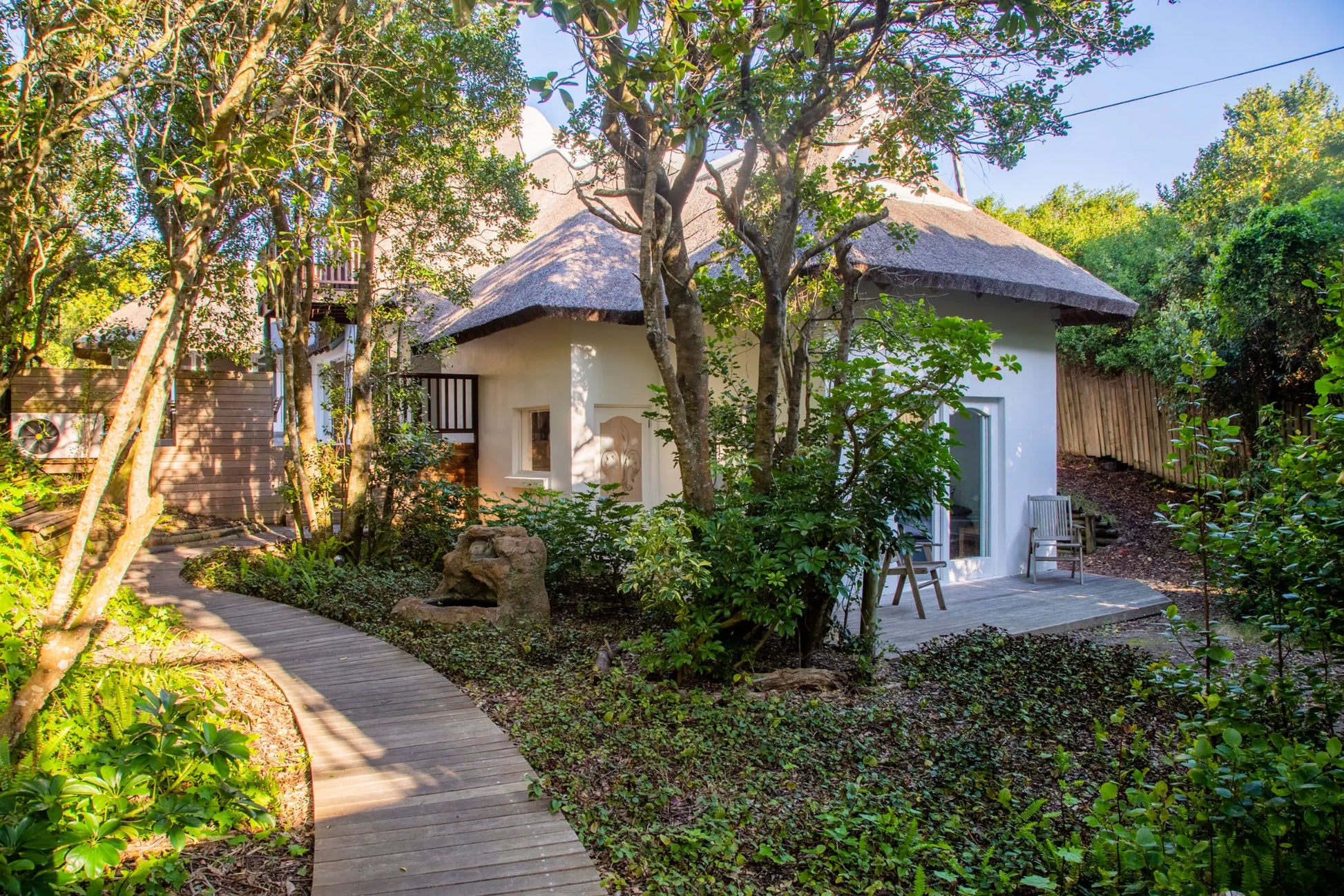 Candlewood Cottage, a thatched holiday villa in St. Francis Bay nestled among Candlewood trees. A serene self-catering retreat sleeping up to 8 guests, featuring elegant, pared-down interiors, a cosy loft with its own TV and kitchenette, and easy access to canals and the beach.