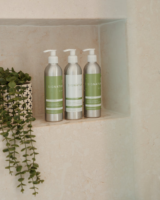 Natural care trio featuring sigNATURE Wash, Shampoo, and Conditioner — all infused with pure essential oils for a luxurious, perfume-like scent. Gentle on skin and hair, locally made, and free from SLS, parabens, and palm oil.
